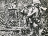 1945-14-02 Marines tote rockets through Bougianville jungle1