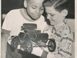 1951-26-04 Children Museum, Mack Yarborough and Mickey Stocker holding a 1900 Automobile1