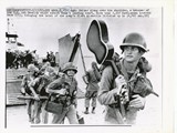 1965-11-09 Soldiers go ashore in Vietnam, one have a guitar slunged over his shoulder1